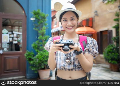Asian women backpacks walking together and happy are taking photo and selfie ,Relax time on holiday concept travel