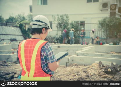 Asian women engineering holds a tablet for use in the inspection of construction sites for accuracy and in accordance with the plan. Concept of Equal rights between men and women