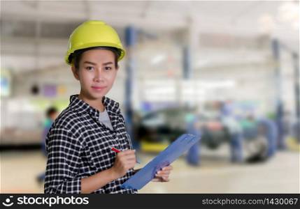 Asian women engineers and technicians mechanic are checking and inspectingthe list on the board of a car in auto repair shop