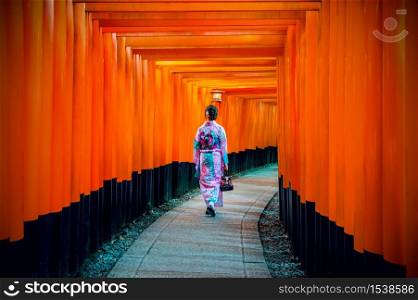 Asian women in traditional japanese kimonos at Fushimi Inari Shrine in Kyoto, Japan.