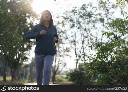 Asian women jogging in the morning garden