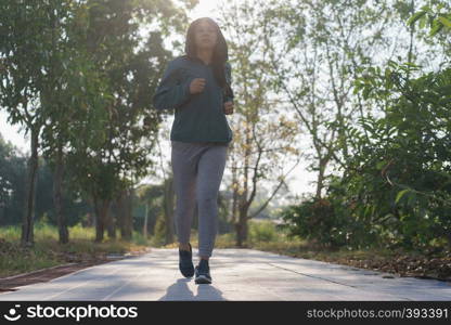 Asian women jogging in the morning garden