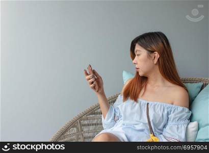Asian women living in a smartphone.. Woman using cellphone