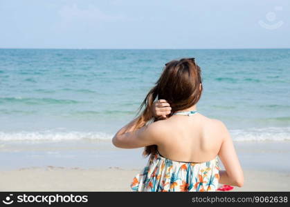 asian women portrait touch her hair on beach