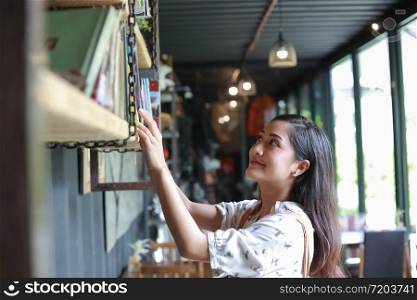 Asian women selection Book for read and smiling happy Relaxing in a coffee shop
