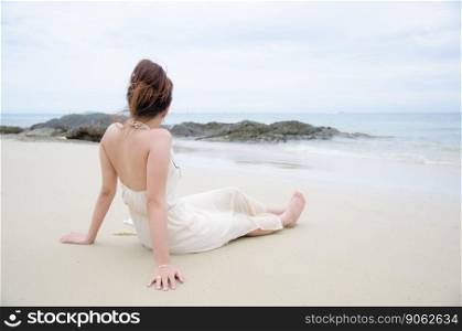 asian women sitting on sea beach