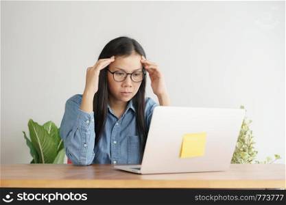 Asian women stressful working with a computer for a long time, Office syndrome concept