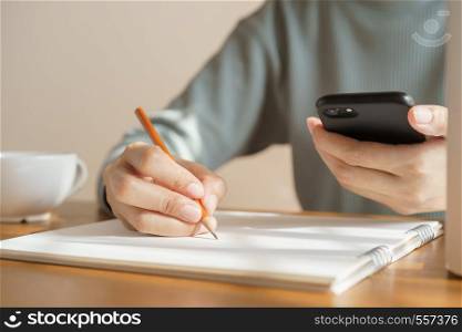Asian women take notes with a a pencil in the office, business woman working on table