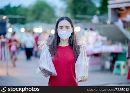 Asian women Thai people use face mask or Surgical mask protect corona virus,Covid 19,New normal life of people in Southeast Asia,Thai women use mask in walking street