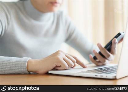Asian women using the phone in the office ,Business woman using a laptop