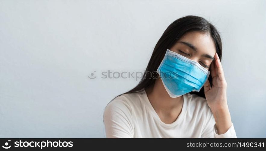 Asian women wear a mask are holding their heads because of headaches. She has a fever and migraine because of stress or sleep late, low sleep, insufficient rest in healthy concept with copy space