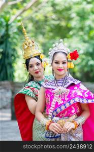 Asian women wearing typical, traditional Thai Dress. National costume in different colors.. Asian women wearing typical, traditional Thai Dress. Traditional dancing.