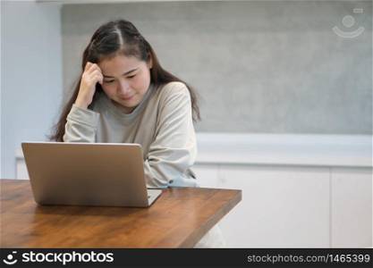 Asian women work from home and stressed due to work problems after being affected by the disease And from a reduced salary. Concept of coronavirus (COVID-19) quarantine