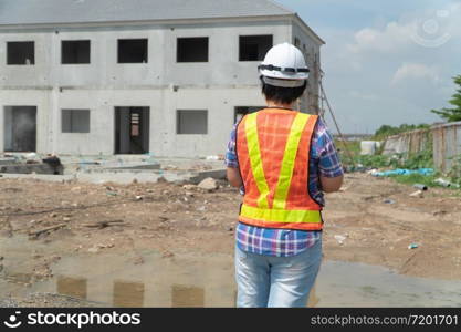 Asian women worker and engineer on building site using tablet for checking the accuracy in places before building and houses.