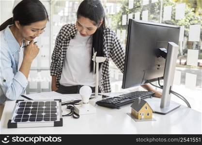 asian women working hard together computer