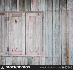 Asian wooden window with the hammered rusty nails on wooden wall background
