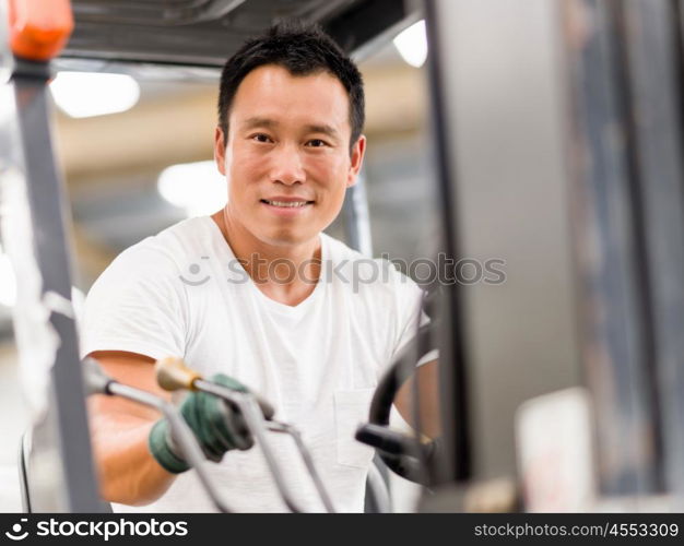 Asian worker in production plant on the factory floor. portrait of asian worker in production plant working on the factory floor