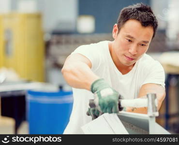 Asian worker in production plant on the factory floor. portrait of asian worker in production plant working on the factory floor