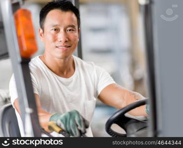 Asian worker in production plant on the factory floor. portrait of asian worker in production plant working on the factory floor