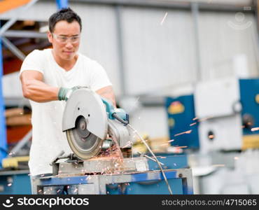 Asian worker in production plant on the factory floor. portrait of asian worker in production plant working on the factory floor