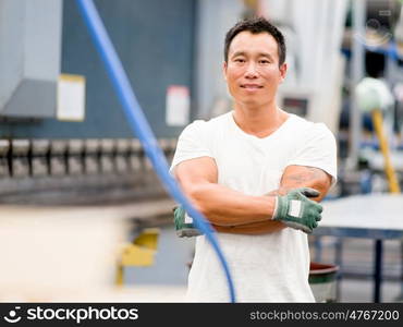 Asian worker in production plant on the factory floor. portrait of asian worker in production plant working on the factory floor