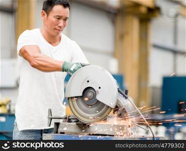 Asian worker in production plant on the factory floor. portrait of asian worker in production plant working on the factory floor