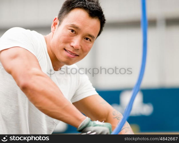 Asian worker in production plant on the factory floor. portrait of asian worker in production plant working on the factory floor