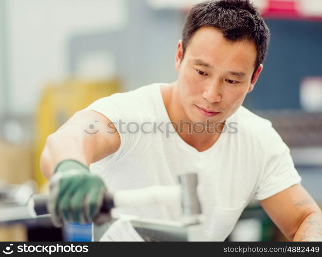 Asian worker in production plant on the factory floor. portrait of asian worker in production plant working on the factory floor