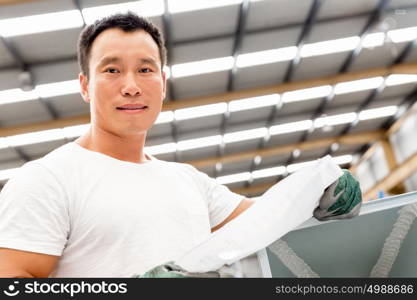 Asian worker in production plant on the factory floor. portrait of asian worker in production plant working on the factory floor