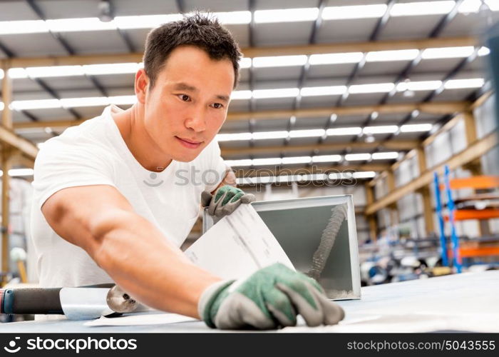 Asian worker in production plant on the factory floor. portrait of asian worker in production plant working on the factory floor