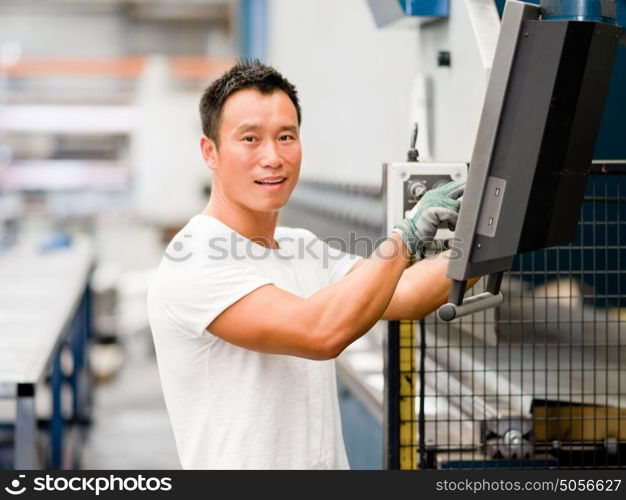 Asian worker in production plant on the factory floor. portrait of asian worker in production plant working on the factory floor