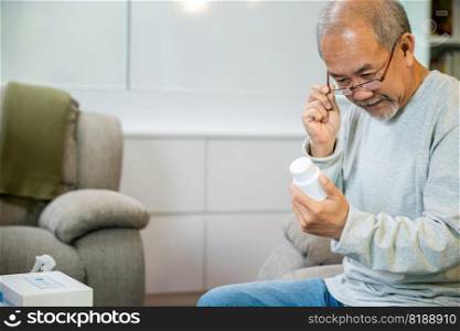Asian worried senior man with medicine pills to taking on table in the living room, old man buy herbal self cure Rx pill online from pharmacy, home isolation, health care help service