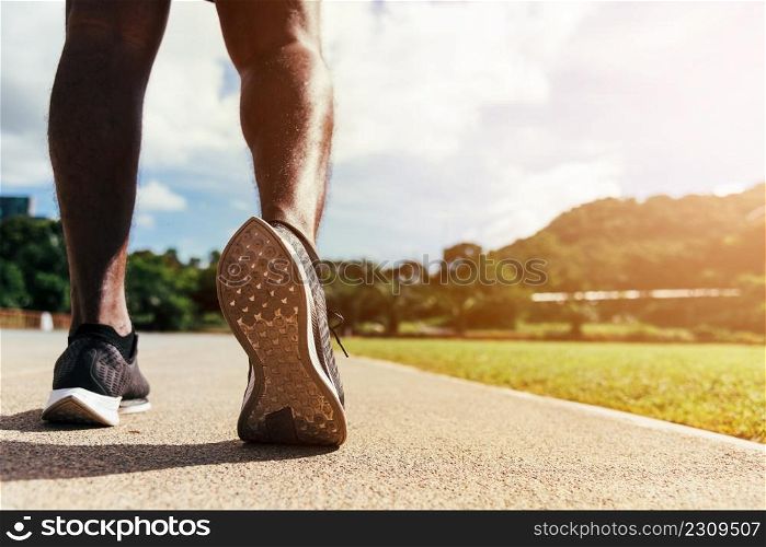 Asian young athlete sport runner black man wear feet active ready to running training at the outdoor on the treadmill line road for a step forward, healthy exercise workout, closeup back shoe