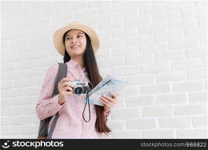 Asian young backpacker tourist, young Asian holding a camera and a map in a white background.