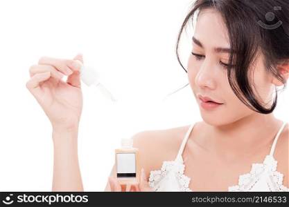 Asian young beautiful woman smiling she&rsquo;s holding bottle serum hair or skin care near face for present product isolated on over white background, Beauty salon concept