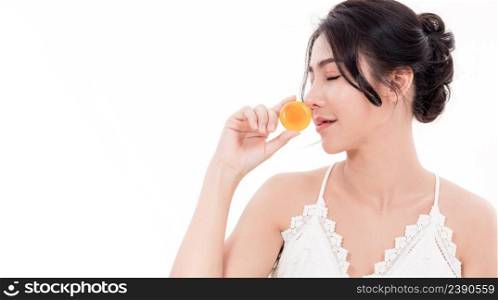 Asian young beautiful woman smiling she’s holding orange handcrafted organic soap skin care near face for present product isolated on over white background, Beauty Zero waste concept