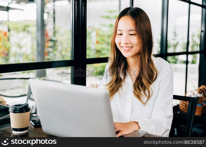 Asian young business woman lifestyle using laptop computer at cafe coffee shop, Happy beautiful freelancer typing keyboard on laptop, working online outside office