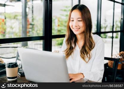 Asian young business woman lifestyle using laptop computer at cafe coffee shop, Happy beautiful freelancer typing keyboard on laptop, working online outside office