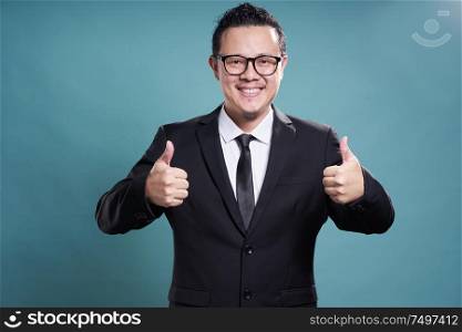 Asian young businessman giving two thumbs-up .
