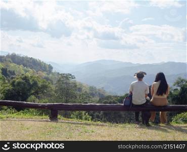 Asian young couple enjoying nature landscape on view point at Mae Wong national park, landmark in Kamphaeng Phet, Thailand.