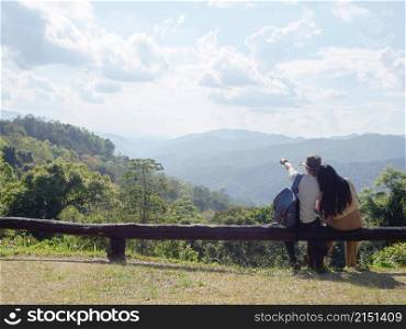 Asian young couple enjoying nature landscape on view point at Mae Wong national park, landmark in Kamphaeng Phet, Thailand.