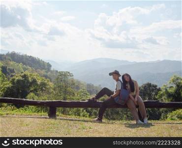 Asian young couple enjoying nature landscape on view point at Mae Wong national park, landmark in K&haeng Phet, Thailand.