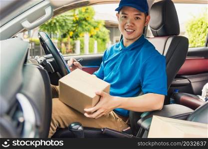 Asian young delivery man courier in uniform hold documents clipboard checking list parcel post boxes inside a car for service shipment to customer, Online shopping service concepts