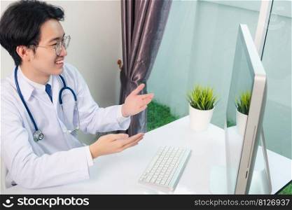 Asian young handsome doctor man wearing a doctor’s dress and stethoscope video conference call or facetime raise hand to explain the symptoms he smiling at hospital office, Health medical care concept