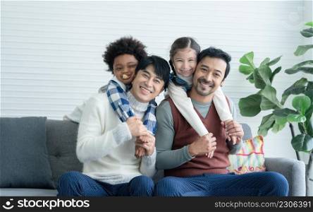 Asian young Lgbtq gay couple enjoy playing with little adopted Caucasian and African kid in living room at home. Happy daughter and son hugging and riding on back of dad. Diverse Lgbt family concept