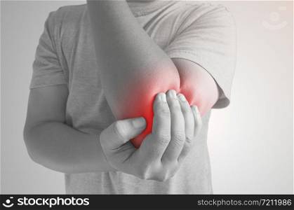 Asian young man having pain in his elbow - sports injury black and white, Disease concept