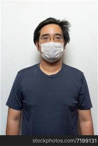 Asian young man in casual shirt wearing surgical medical mask to protect virus with isolated on white background.Wuhan coronavirus (COVID-19) outbreak prevention. Health care concept
