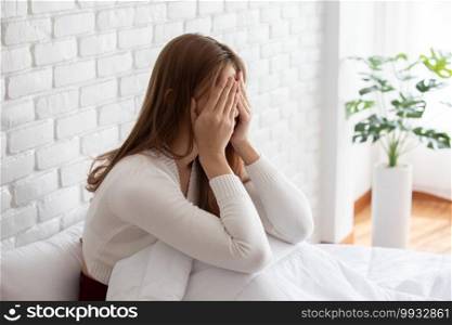 Asian young Woman has a Migraine and headache after wake up in the morning,Healthcare Concept
