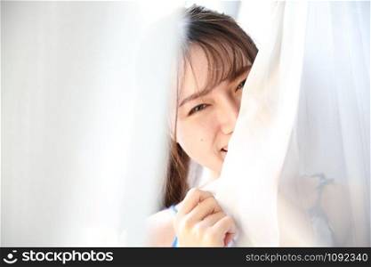 Asian young woman portrait in bed room with white tone