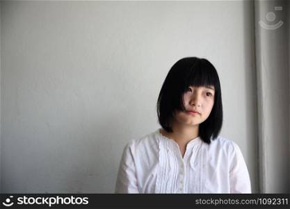 Asian young woman thinking and looking portrait in coffee shop cafe